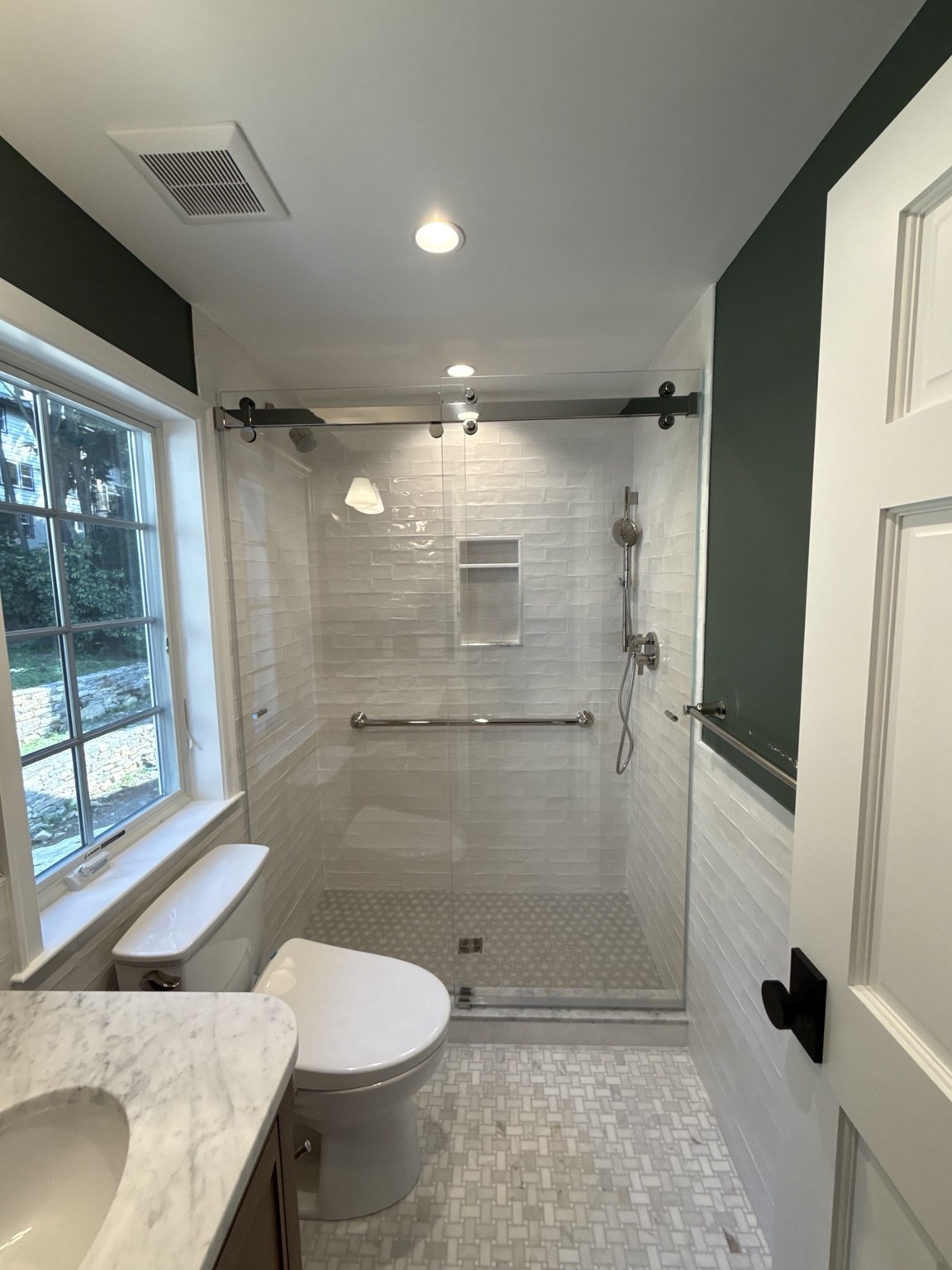Sliding Shower Enclosure — Sliding shower glass with a black top rail