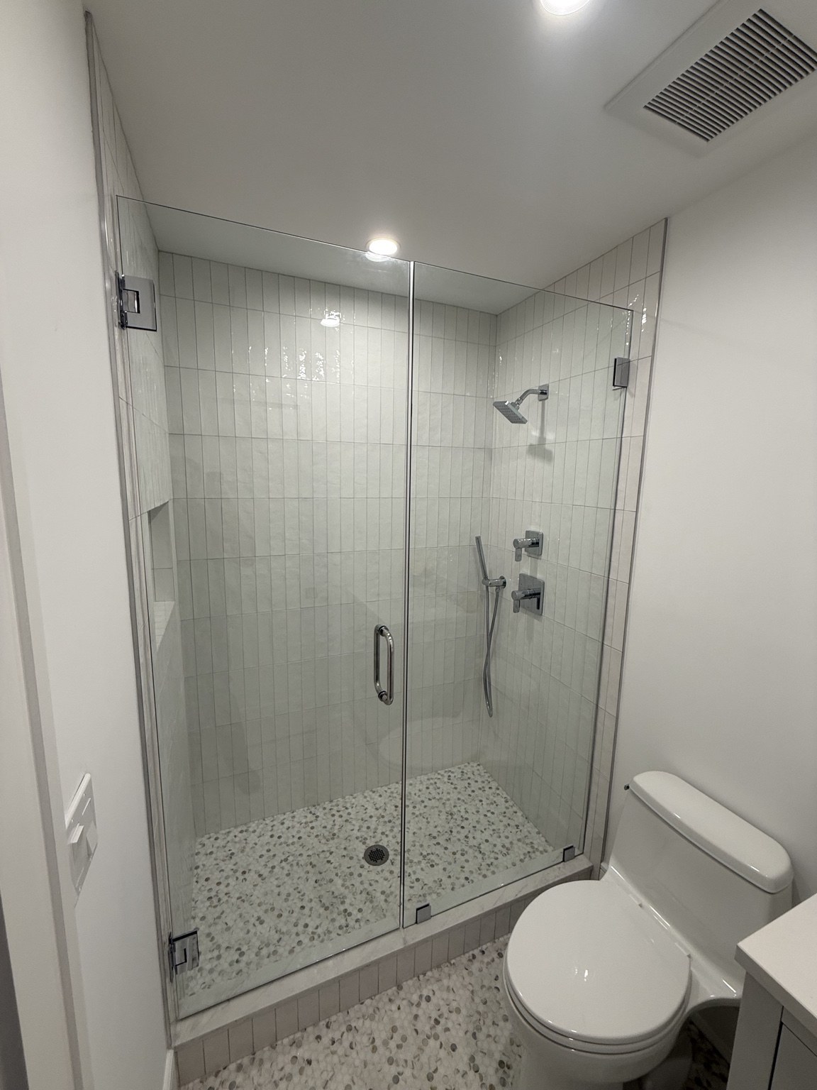 Door & Panel — Wall-hinged shower door with a fixed glass panel