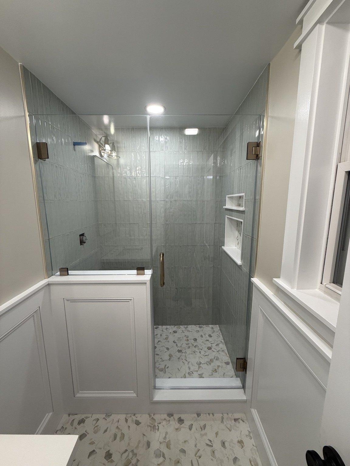 Door & Pony-Wall Panel — Wall-hinged shower door with a fixed panel above the pony wall
