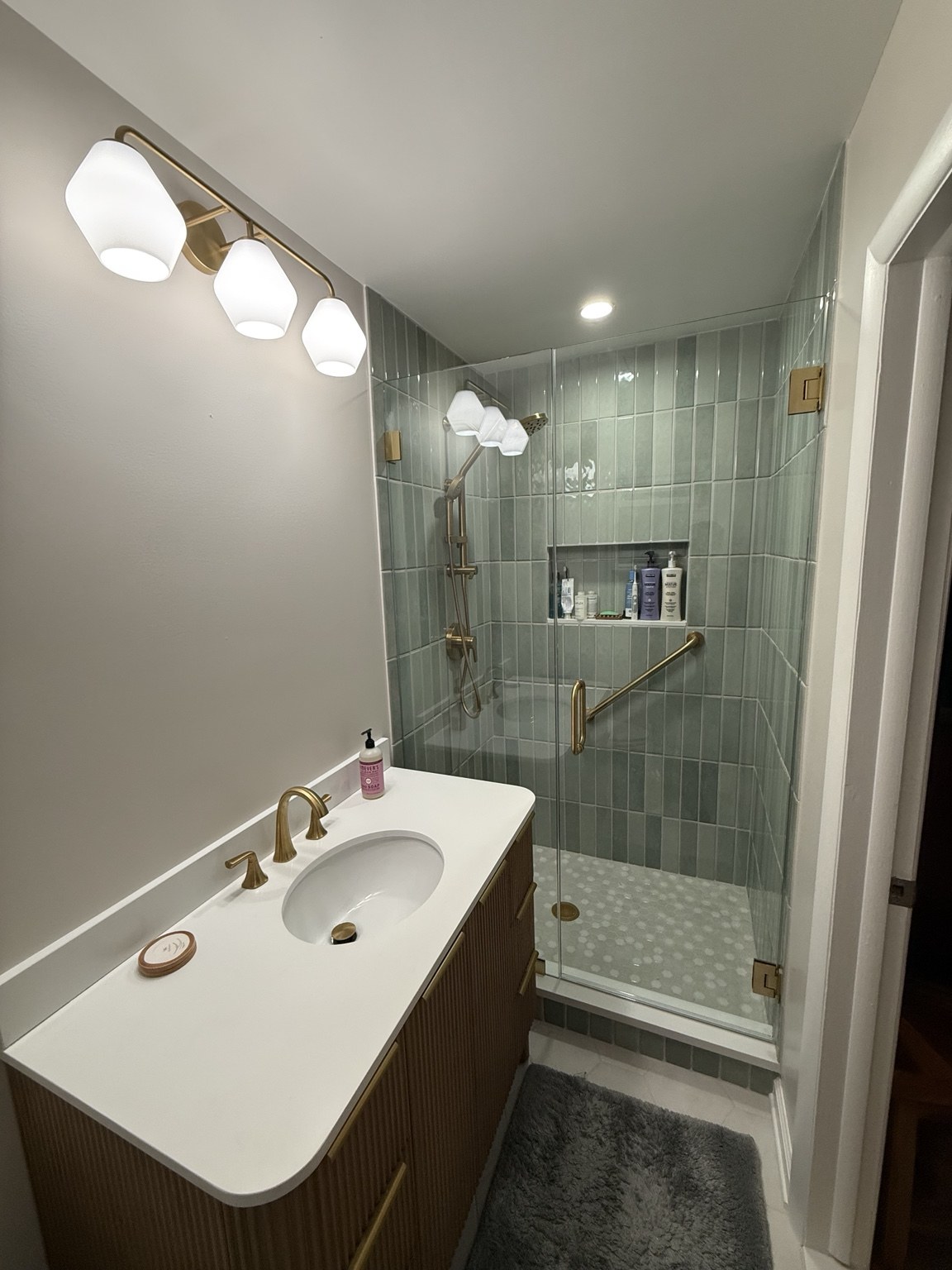 Door & Panel Shower — Hinged shower door beside a fixed glass panel